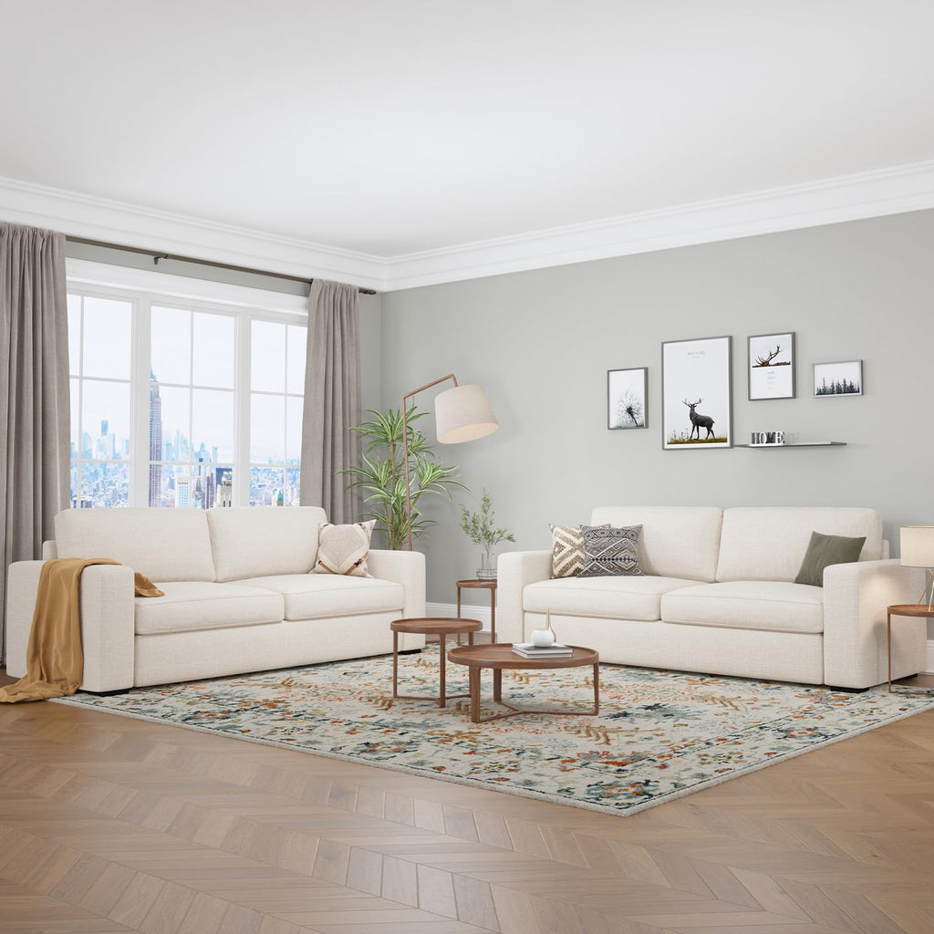 A pair of Alba ivory cream faux linen sofas in a modern living room.