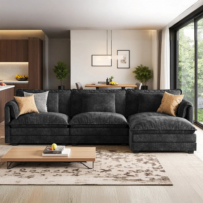 A bright, sunlit living room showing the ABCASA Cloud black sofa by a large window.