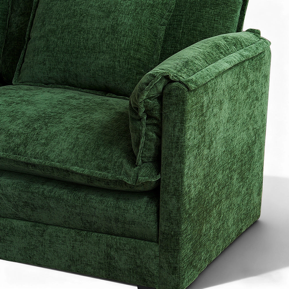 Close-up angled view of the ABCASA Cloud modular sofa armrest and seat cushion in forest green chenille fabric.
