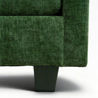 Close-up of a green upholstered chair corner on a white background