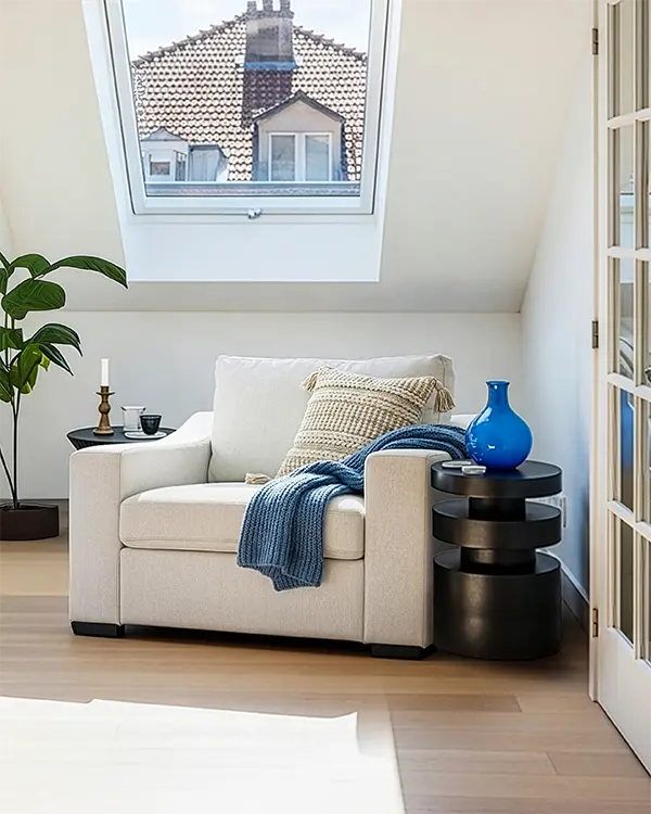 Modern loft corner with ABCASA Cove Accent Chair, blue vase, and candle.