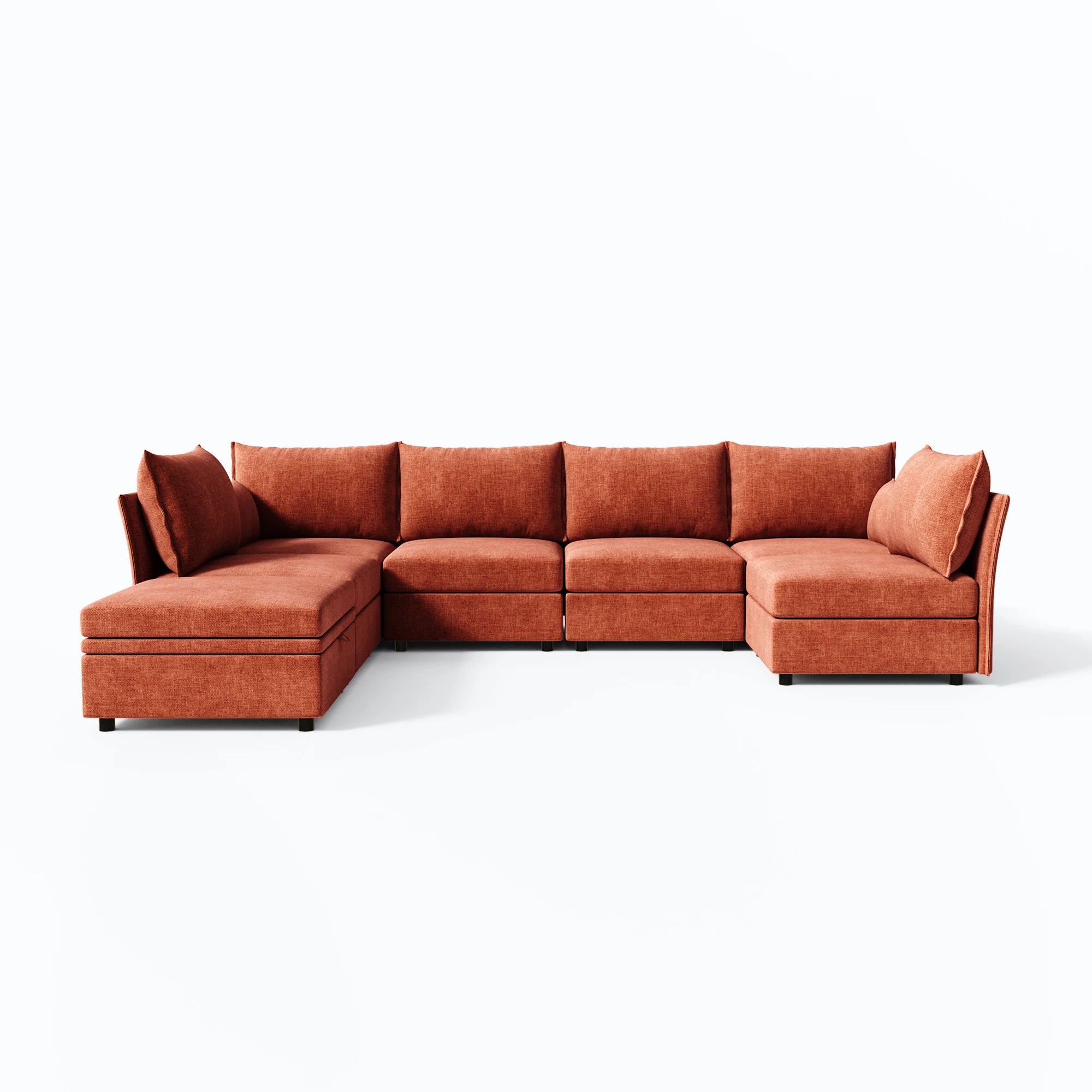 Front view of the 7-piece Huddle modular sofa in terracotta, featuring an asymmetrical layout with a left-side ottoman.