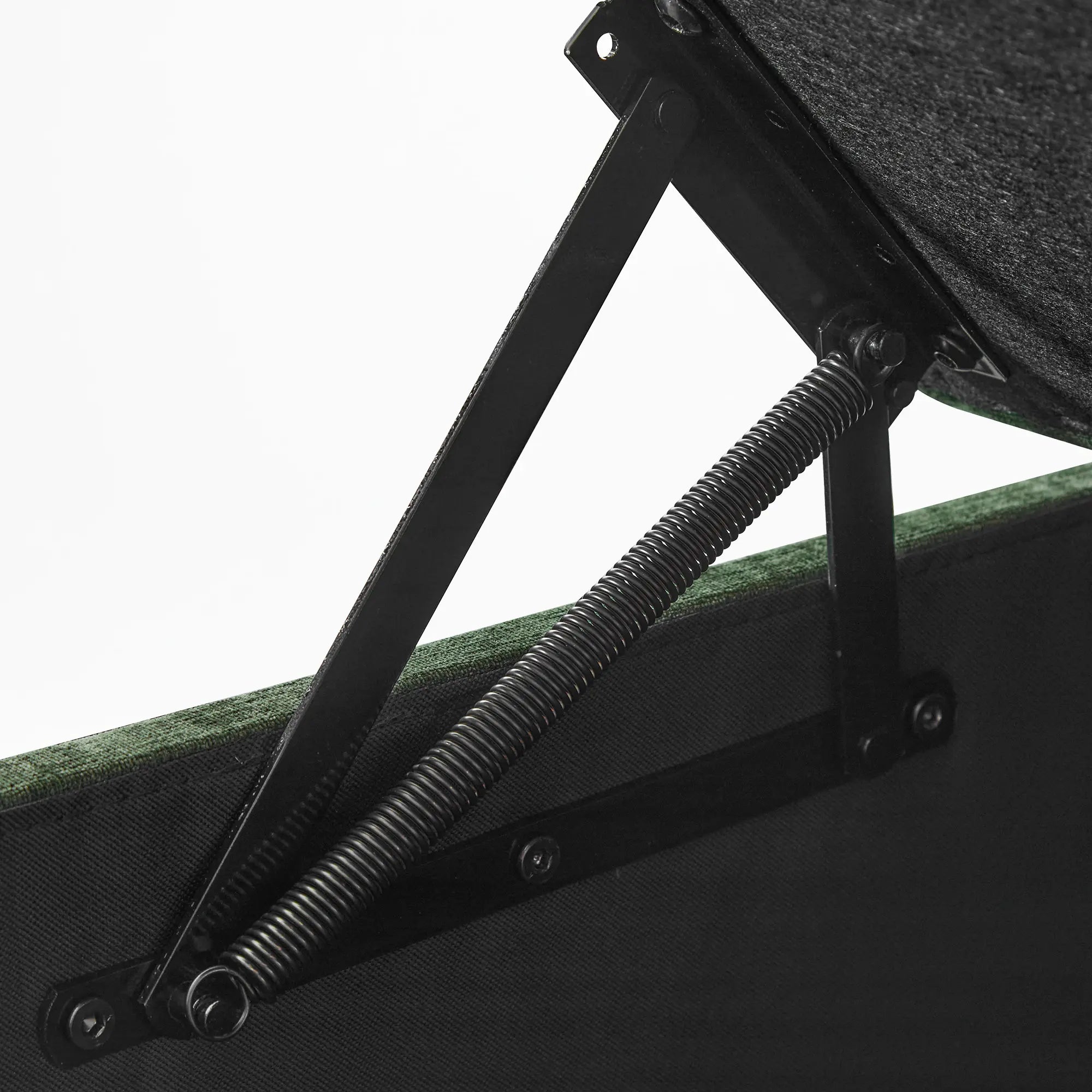 Close-up of a Huddle green ottoman with a black spring mechanism.