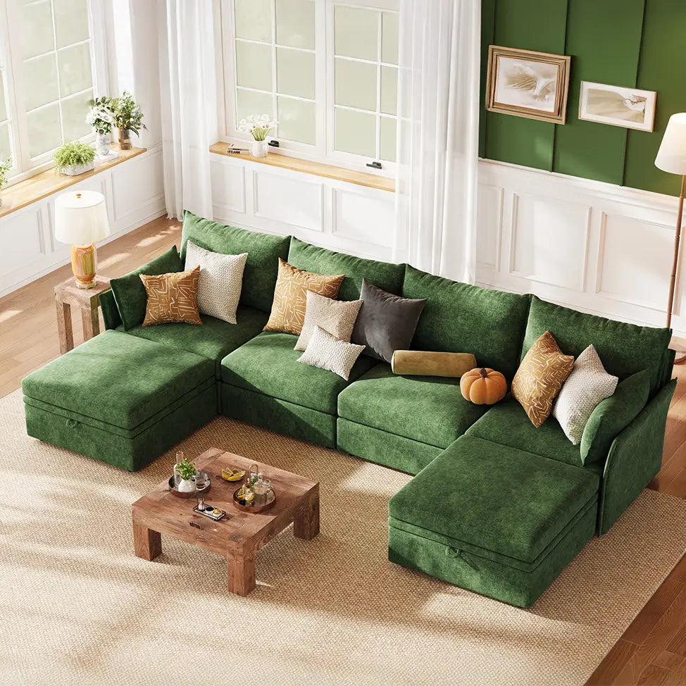 A minimalist modern living room featuring the ABCASA Huddle green modular sofa against a clean, white backdrop with subtle decor.