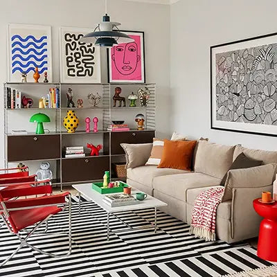 Modern apartment with ABCASA Huddle Modular Sofa in beige, red chairs, and colorful decor