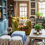 Cozy maximalist living room with an ABCASA Huddle yellow armchair, ottoman, and decorative items.