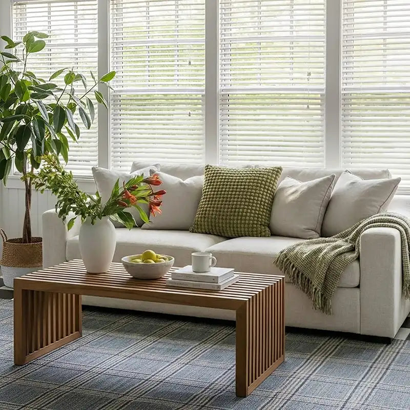 Living room with a white ABCASA Cove sofa, wooden coffee table, and decorative items.