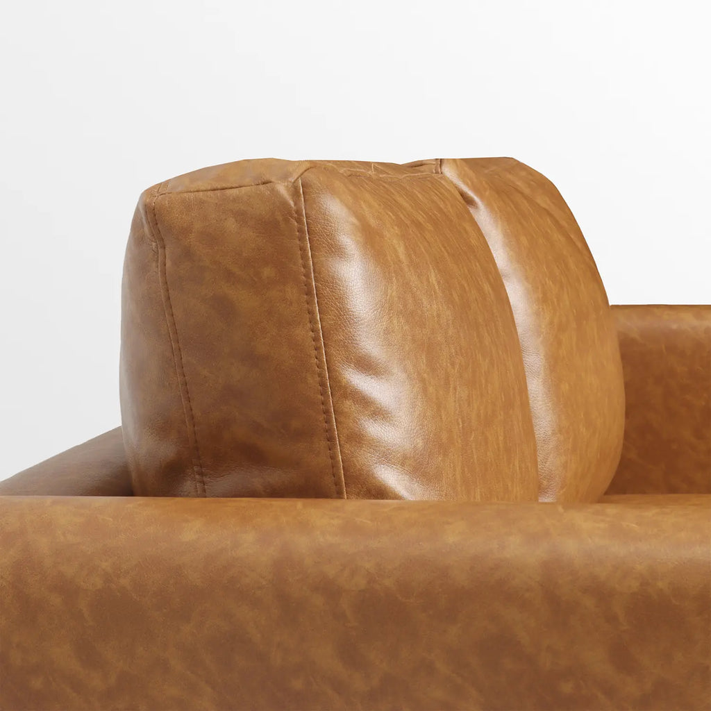 Detail shot of the plush, thick back cushion on the Moro faux leather sofa.
