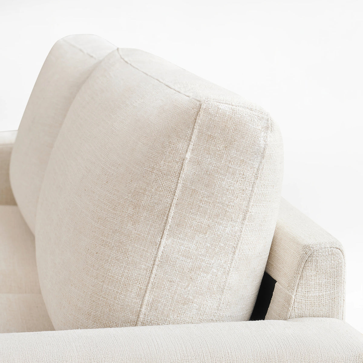 Detail shot of the thick back cushion of the Alba ivory faux linen sofa.