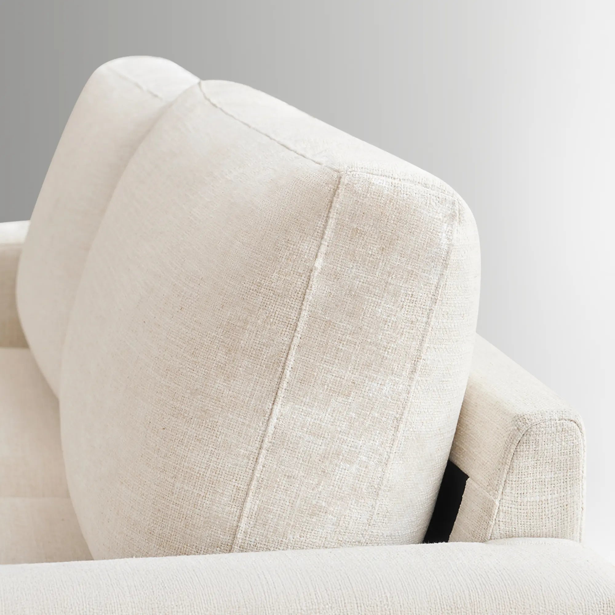 Detail shot of the thick back cushion of the Alba ivory faux linen sofa.