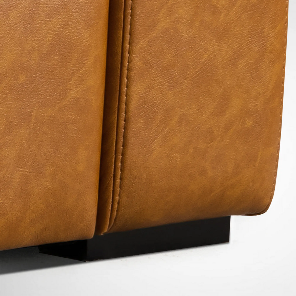 Detailed view of the furniture leg on the Alba saddle tan leather sofa.