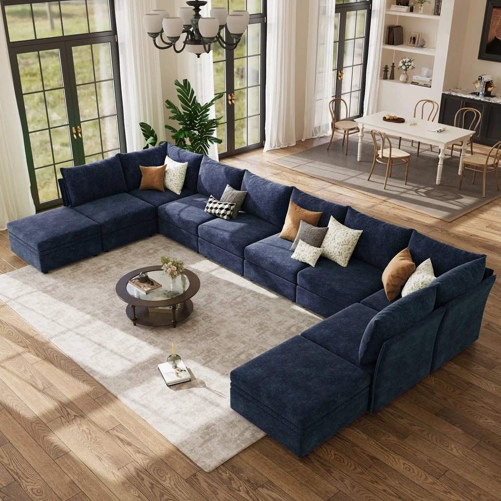 Overlook ABCASA Huddle navy blue sectional sofa in a living room with a coffee table and decorative pillows.